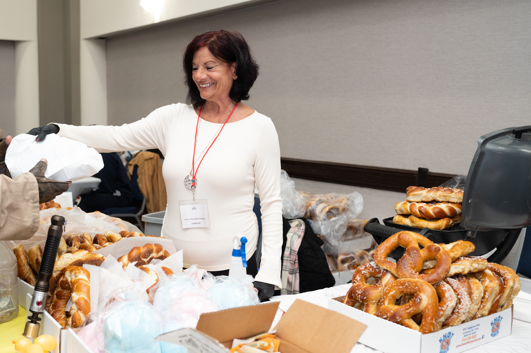 A woman sells pretzels
